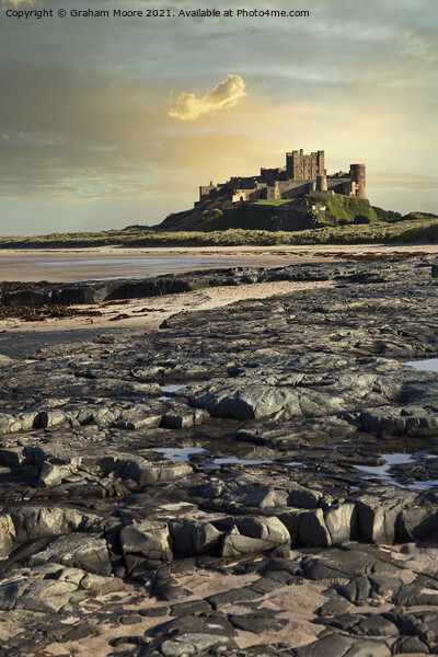 Bamburgh Castle from rocky beach Picture Board by Graham Moore