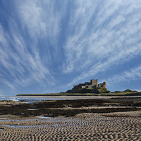 Buy canvas prints of Bamburgh Castle with streaky clouds by Graham Moore