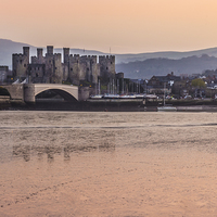 Buy canvas prints of Conwy Castle and harbour at dusk by Paul Madden