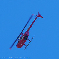 Buy canvas prints of Red R44 helicopter from below by Malcolm Snook