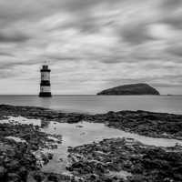 Buy canvas prints of  Moody Sky at Penmon Lighthouse mono by Pete Lawless