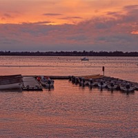 Buy canvas prints of Moored Boats at sunset by Avril Harris