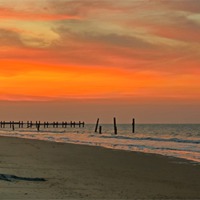 Buy canvas prints of Sunset on Happisburgh Beach by Avril Harris
