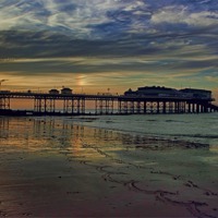 Buy canvas prints of Cromer Pier at sunset by Avril Harris