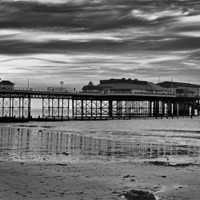 Buy canvas prints of Cromer Pier in black and white by Avril Harris