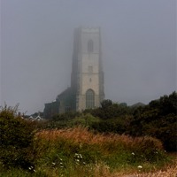 Buy canvas prints of Ghostly Happisburgh church in a sea fret by Avril Harris