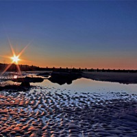 Buy canvas prints of Sunset at Walcott Beach by Avril Harris