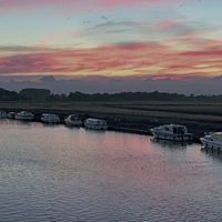 Buy canvas prints of Acle river bure sunset by Avril Harris