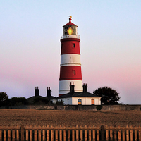 Buy canvas prints of Happisburgh lighthouse shining by Avril Harris
